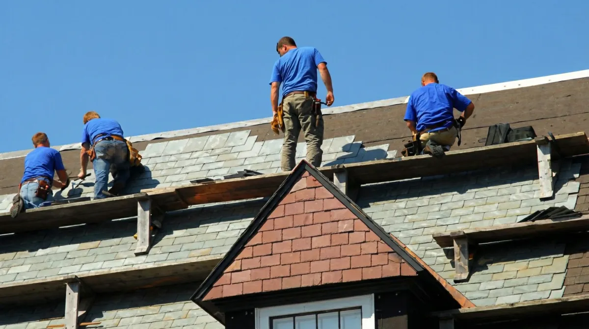Roof replacement in progress with a team of professional contractors installing new shingles on a residential home in Portland, OR